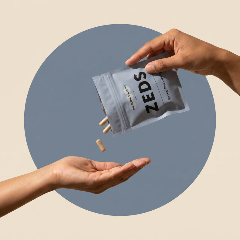 Hands pouring the ZEDS sachet, tan capsules falling into an open palm below